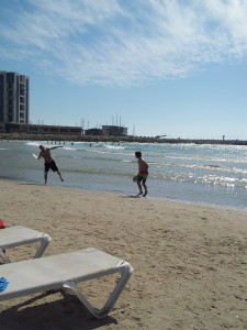 Me and my dad playing beach paddle ball at Herzlyia Beach